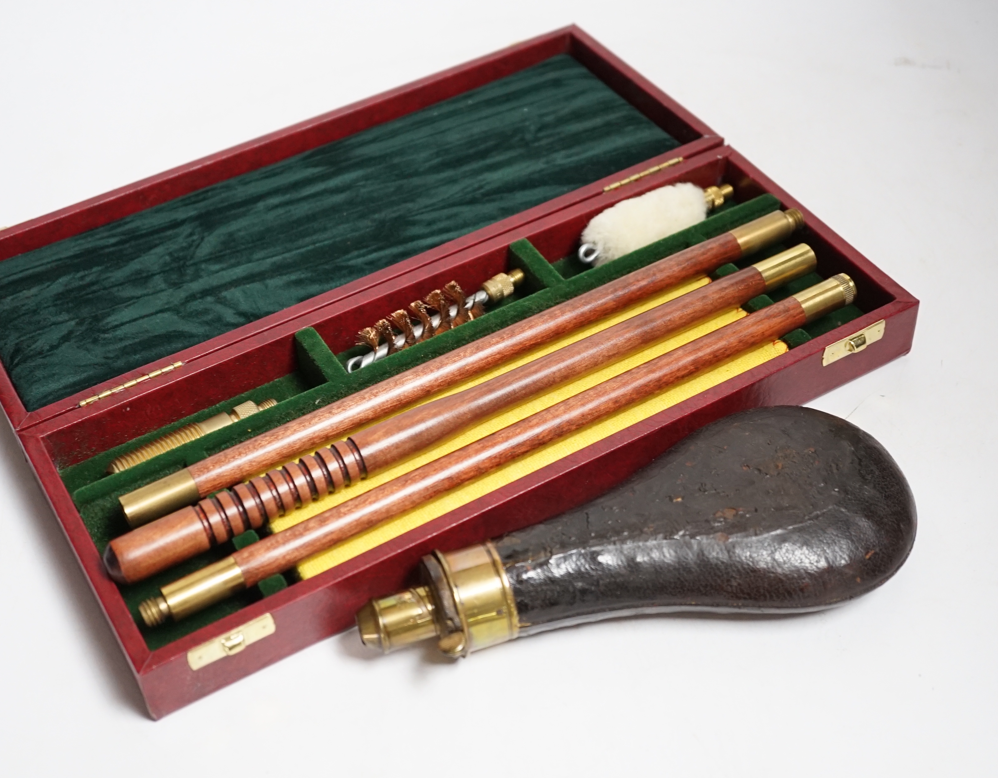 Three copper powder flasks, a leather powder flask, two powder measures and two cases of cleaning tools